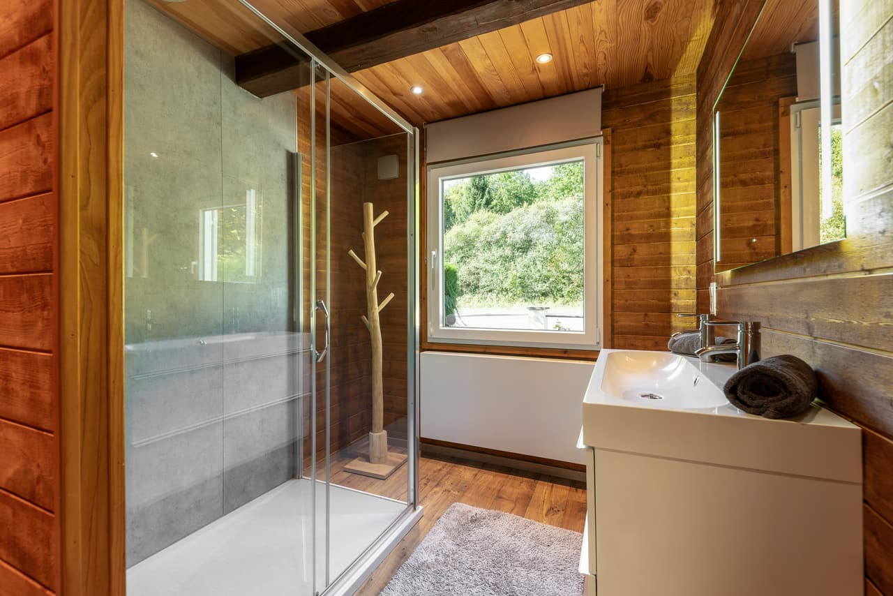 Glazed walk-in shower beside the basin
