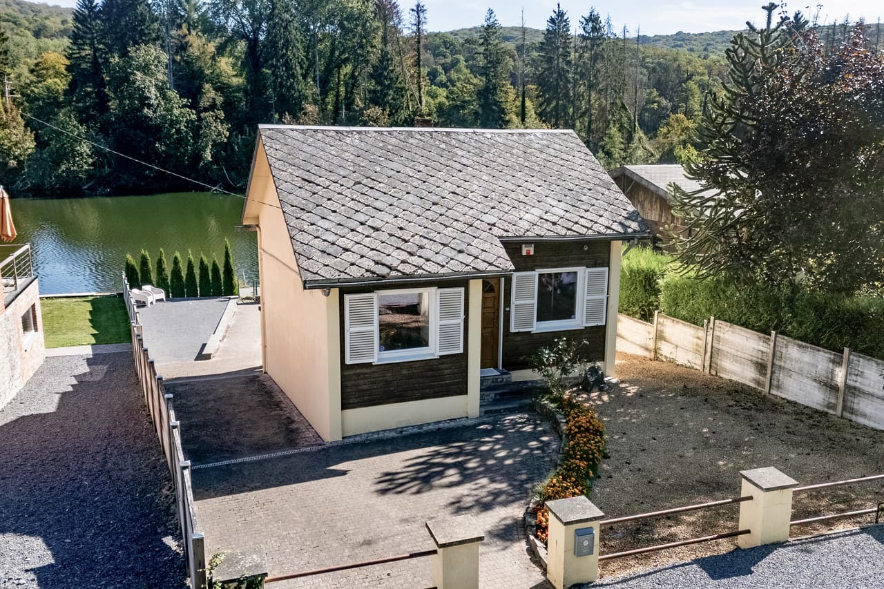 Small house with a slate roof, beside the water