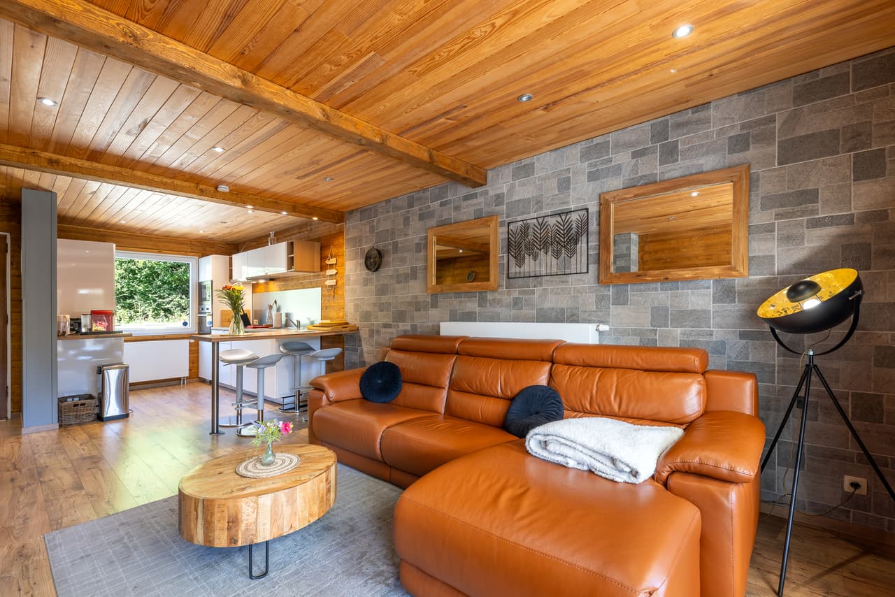 Living room seen from the kitchen, with the counter and leather sofa