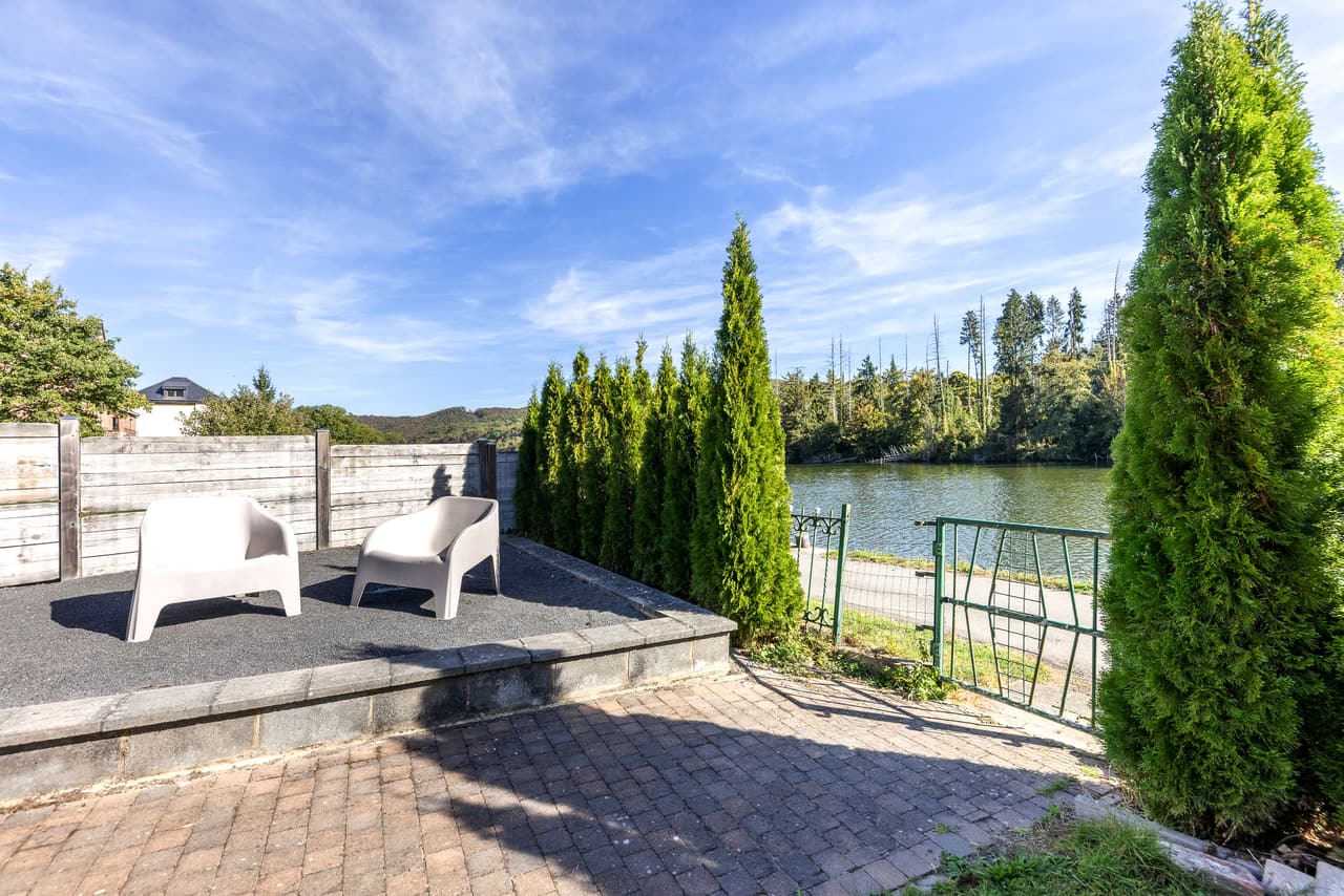 Terrace by the water, with two armchairs