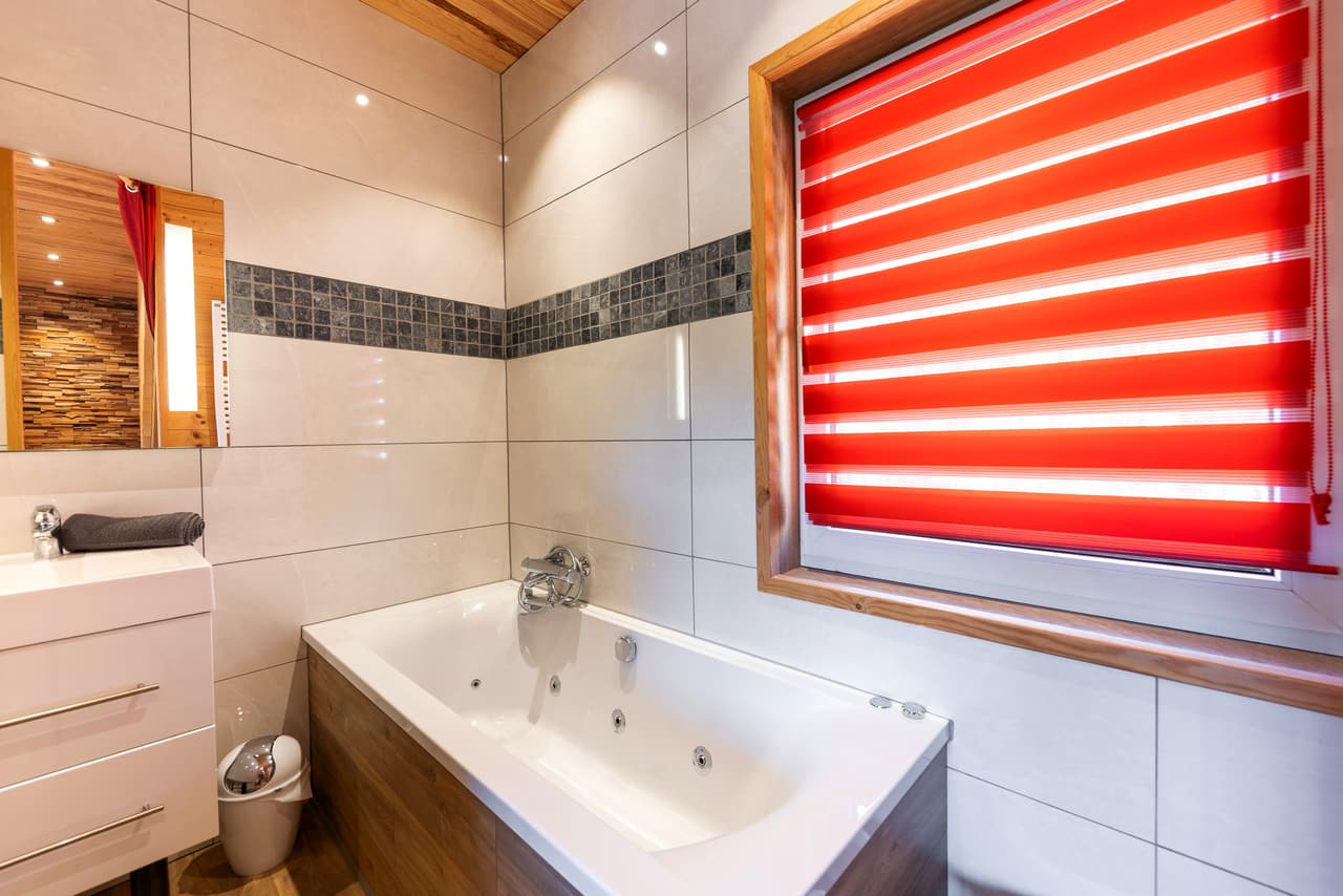 Whirlpool bath in the tiled bathroom