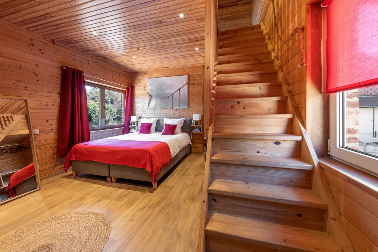 The same bedroom and the wooden stairs going up