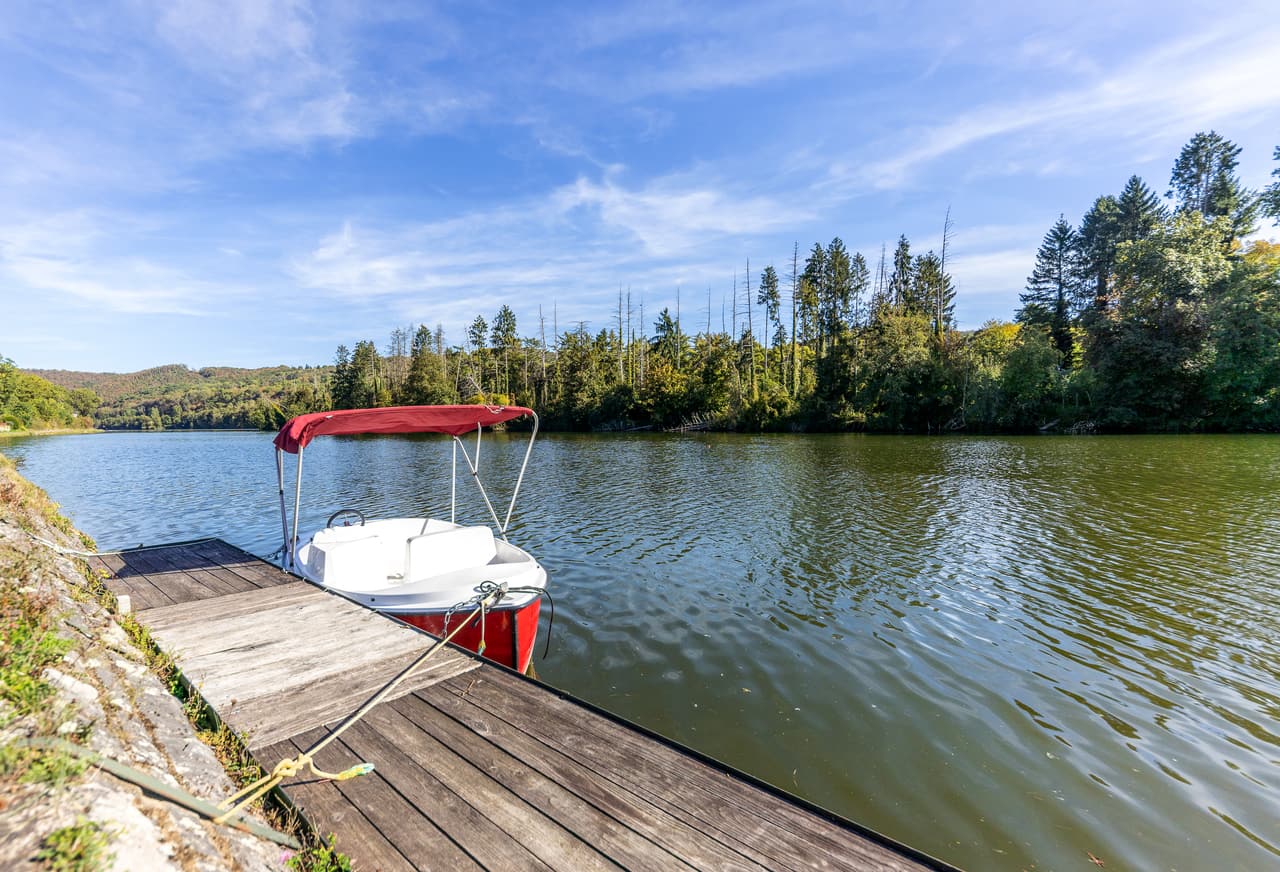 Electric boat moored at the pontoon on the Meuse