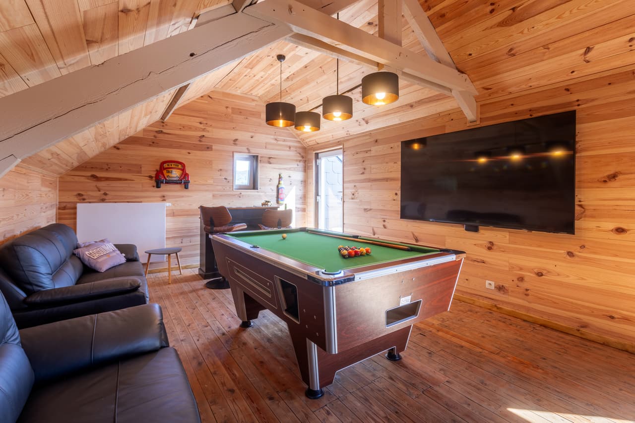 American pool table and screen in the attic room
