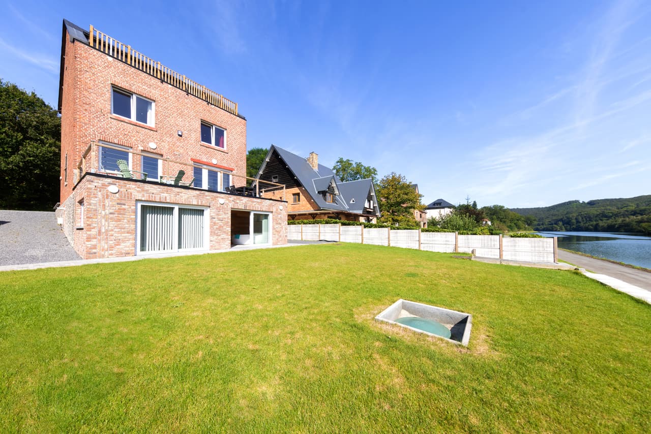 Brick front and lawn, with the Meuse at the end of the garden