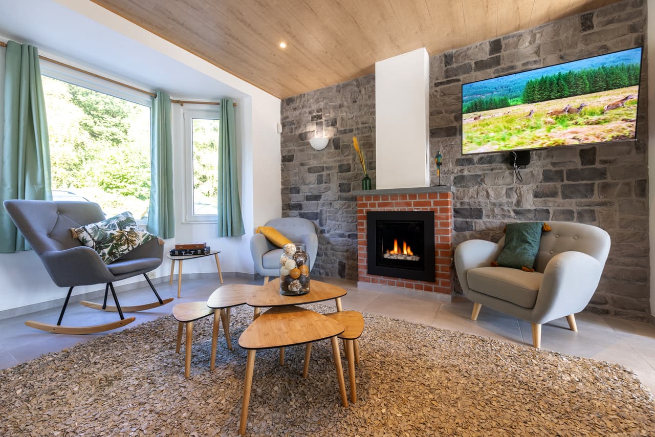 Sitting corner with rocking chairs and a gas fire in the stone wall